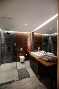 a bathroom with a sink and a shower at Town Hall Square Apartment in Tallinn