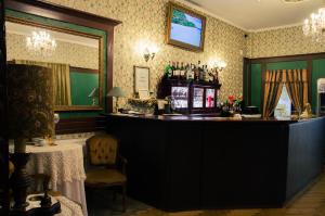 a bar in a room with a table and a mirror at ''Zatoka" in Bydgoszcz