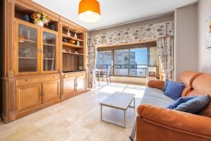 a living room with a couch and a table at Los Pinos 9B Apartment Levante Beach-Old Town in Benidorm