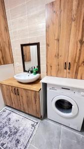 a bathroom with a sink and a washing machine at 3 комнатная квартира Бесагаш Сити in Almaty
