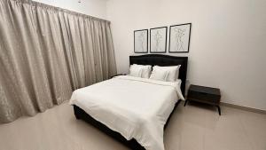 a bedroom with a large bed with white sheets and pillows at Oceanfront Villa 5BHK with private pool and seaview in Fujairah