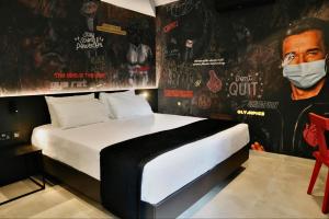 a bedroom with a bed with a mask on the wall at SO City Hotel Adults Only in St. Julianʼs