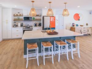 a kitchen with a large blue island with bar stools at New: Dome, Hot Tub, Game Room, 5 min to park in Joshua Tree