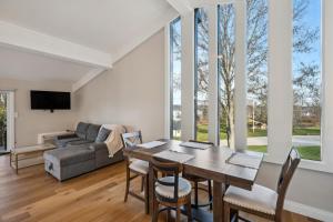 a living room with a table and chairs and a couch at Elegant 4-Season Lake Geneva Condo with Fireplace! in Lake Geneva