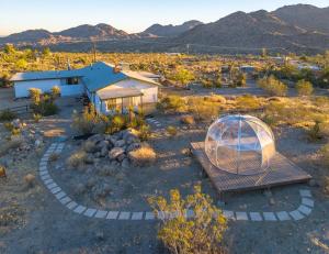 a house in the middle of a desert with a tent at New: Dome, Hot Tub, Game Room, 5 min to park in Joshua Tree