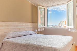a bedroom with a bed and a large window at Alla Marina Affittacamere in Riomaggiore +93 photos