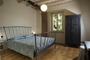 a bedroom with a black bed and a window at Il Colombee in Montevecchia