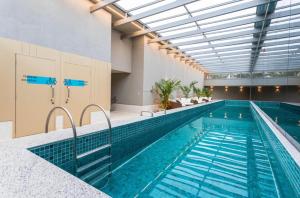 an indoor swimming pool with a large swimming pool at Studio aeroporto Congonhas in São Paulo