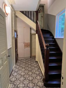 a hallway with a staircase with a tile floor at Villa Lattermann in Muldenhammer