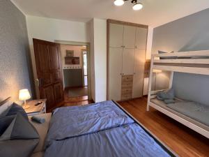 a bedroom with a bed and a bunk bed at Villa Lattermann in Muldenhammer