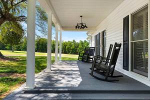 a porch with rocking chairs on a house at Three Silos Farm -Chatt Hills (NEW & Pet Friendly) in Chattahoochee Hills