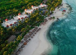 an aerial view of a resort on a beach at El Dorado Royale Catamarán, Cenote & More Inclusive in Puerto Morelos