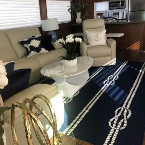 a living room with a couch and a table at Luxury Afloat Yacht Paradise 3 bedrooms 3bath 5 beds with full Marina view in Los Angeles