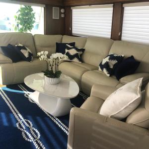 a living room with a couch and a table with pillows at Luxury Afloat Yacht Paradise 3 bedrooms 3bath 5 beds with full Marina view in Los Angeles