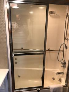 a shower with a glass door in a bathroom at Luxury Afloat Yacht Paradise 3 bedrooms 3bath 5 beds with full Marina view in Los Angeles