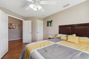 a bedroom with a large bed and a ceiling fan at Pet-Friendly Cape Coral Retreat with Screened Porch! in Cape Coral