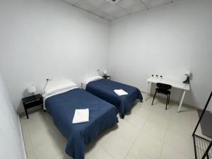 Postel nebo postele na pokoji v ubytování Hostal Kaizen
