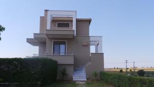 a building with a staircase in front of it at Niovi Boutique Apartments in Afitos