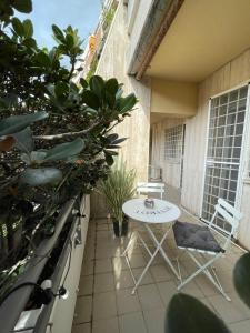 a patio with a table and chairs on a balcony at Stanza classica Eur Tintoretto in Rome