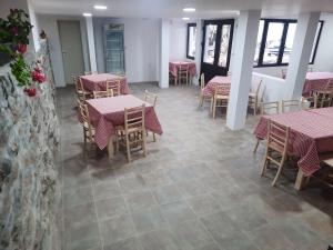 a restaurant with tables and chairs with pink table cloth at Kladenče in Pirot
