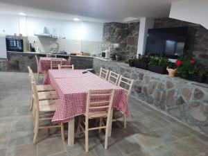 a dining room with a table and chairs and a tv at Kladenče in Pirot