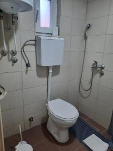 a bathroom with a toilet and a sink and a window at Kladenče in Pirot