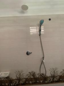 a shower with a blow dryer in a bathroom at Original track by Unrushed in Weligama