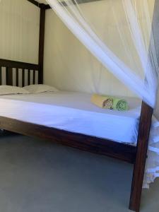a bed with a canopy in a room at Original track by Unrushed in Weligama