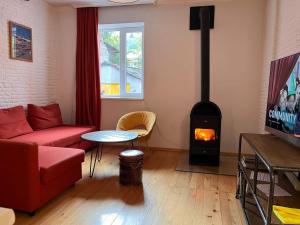 a living room with a couch and a wood stove at svaneti apartment's in Mestia