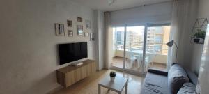 a living room with a flat screen tv on a wall at Balcon al mar in Bellreguart