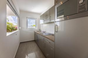 a kitchen with a white refrigerator and a sink at Palm Crest in Willemstad