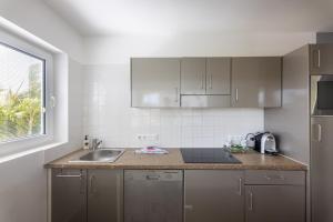 a kitchen with a sink and a counter top at Palm Crest in Willemstad