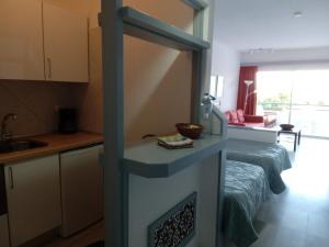 a kitchen with a stove in the middle of a room at Club Atlantis studio 160 - Playa de Las Americas in Adeje