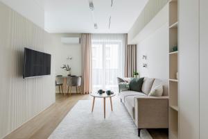 TV a/nebo společenská místnost v ubytování Cosy Studio Paupys