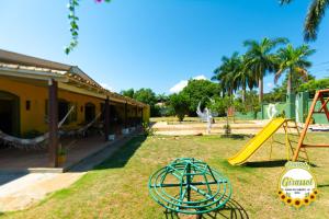 um quintal com escorrega e um parque infantil em Pousada Girassol em Chapada dos Guimarães