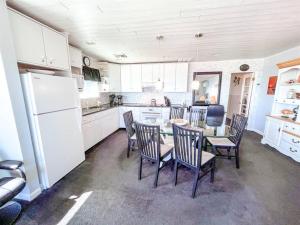 a kitchen with a table and chairs and a refrigerator at Ocean front * Boardwalk * Private Balcony in Ocean City