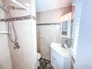 a bathroom with a toilet and a sink and a shower at Ocean front * Boardwalk * Private Balcony in Ocean City