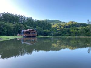 a house sitting on top of a large lake at Refúgio das Uvas * Casa do Lago in Frederico Westphalen