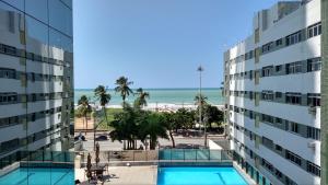a view of the beach from the balcony of a building at Boa Viagem 420 Apart Hotel in Recife