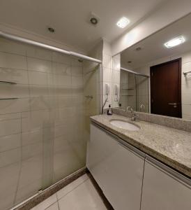 a bathroom with a sink and a mirror at Boa Viagem 420 Apart Hotel in Recife