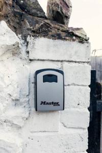 a box on the side of a brick wall at Cosy hillside cottage in Great Malvern