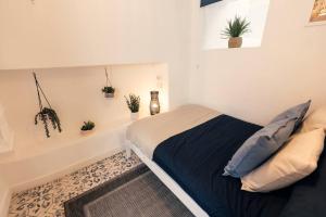 a bedroom with a bed and potted plants on the wall at Cosy hillside cottage in Great Malvern