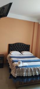 una camera con un letto con una coperta blu e bianca di HOSTAL LLAUT * * a Moquegua
