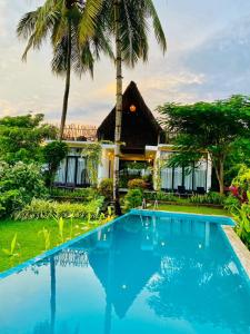 坦加拉的住宿－Kalametiya Bird Villa，棕榈树屋前的游泳池
