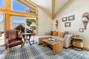 a living room with a couch and a table at Outbound Mammoth in Mammoth Lakes