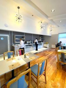 a kitchen with a table and two people in the kitchen at Hotel Nahuel Huapi in San Carlos de Bariloche