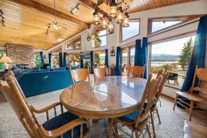 a dining room with a wooden table and chairs at North Shore Lakefront - Spacious Lakefront with Hot Tub, & Game Room in Fawnskin
