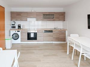 a kitchen with white appliances and a table and chairs at T&K Apartments - Wegberg - 3-6 Zimmer Apartments in Wegberg