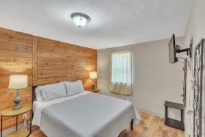 a bedroom with a white bed and a window at Downtown 2 story property apts in Spearfish