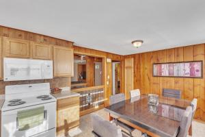 a kitchen with wooden walls and a table with chairs at Downtown 2 story property apts in Spearfish